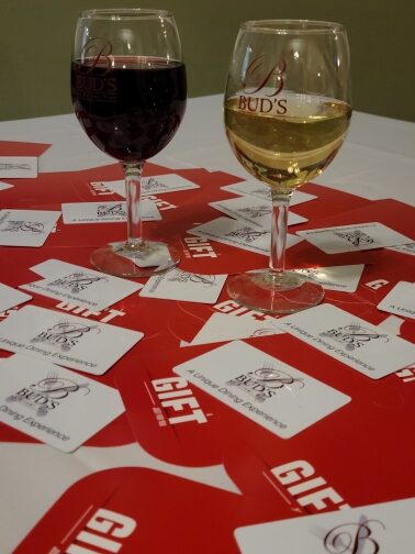 Glasses of wine and Gift Cards on a table
